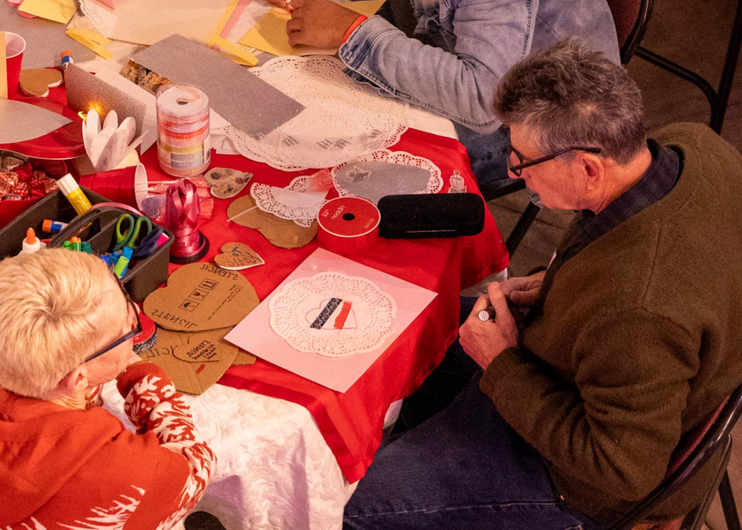 Volunteers working on crafts at a table